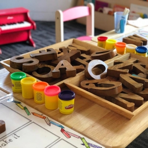 Nursery table with play clay and wooden letters