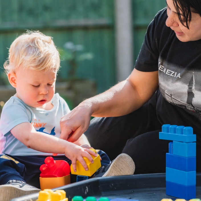 Photograph of a toddler playing & learning with staff at Little Cedars Day Nursery, Streatham.