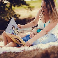 Childcare professionals read with all children at Little Cedars Nursery in Streatham