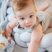 It may help initially to support babies with a rolled-up towel, blanket or similar.