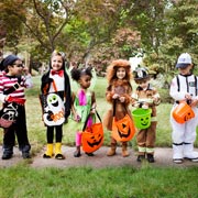 Combine the Halloween fancy dress costumes, spooky decorations, and themed food and drink by hosting a Halloween party!