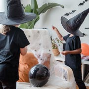 Black sheets or clothes are easy to make into witch or wizard outfits. Add pointy hats made from card.