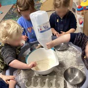 Children from Little Cedars Nursery mixing ingredients on Pancake Day.