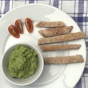 Pitta slices, a mashed avocado dip, and diced tomatoes.
