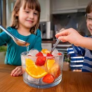 Freeze fruit or suitably sized small toys in ice and then get children to release them using warm water.